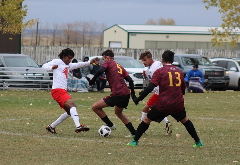 Olds College and SAIT Soccer Athletes compete for ball on soccer field